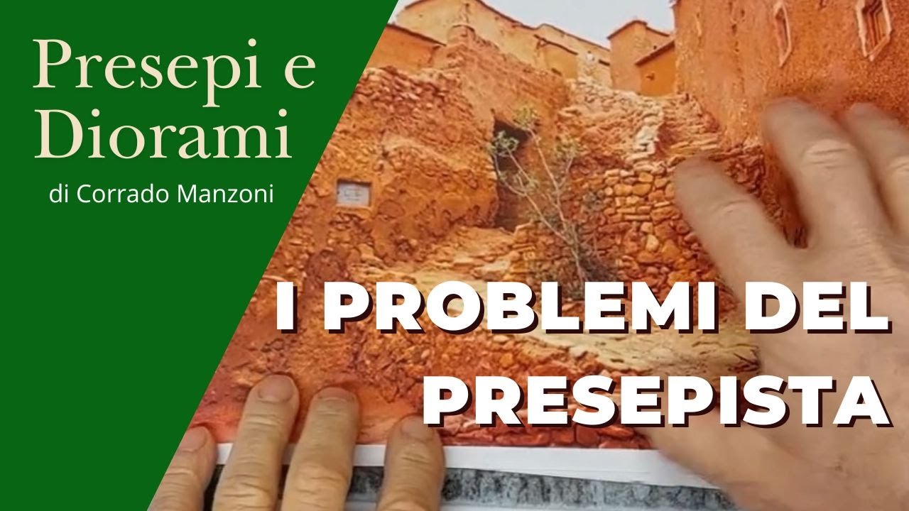 Mani che mostrano una foto di un borgo antico in mattoni rossi con il titolo "I Problemi del Presepista" e il logo "Presepi e Diorami di Corrado Manzoni"